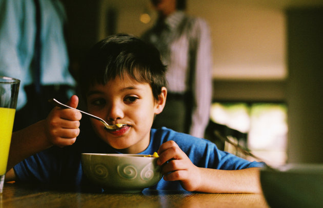 A picture of a boy eating cereal