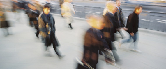A blurry picture of people walking down a street