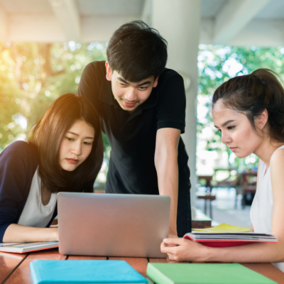 three young people with laptop