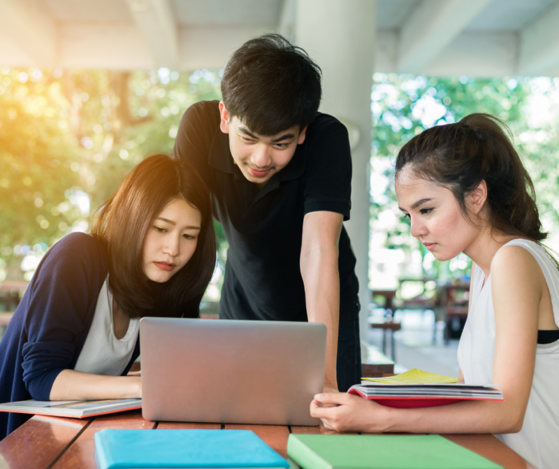 three young people with laptop