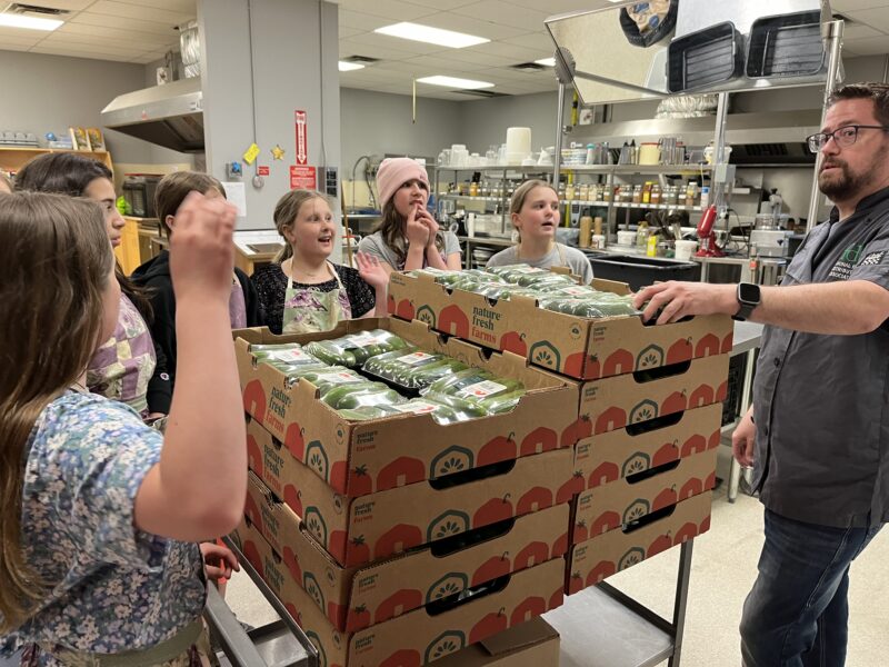 kids with cucumbers at the food bank