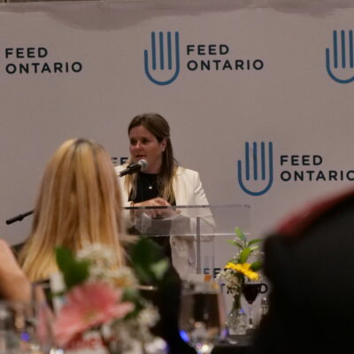 Carolyn Stewart, Feed Ontario CEO, presenting the leadership awards at our conference.