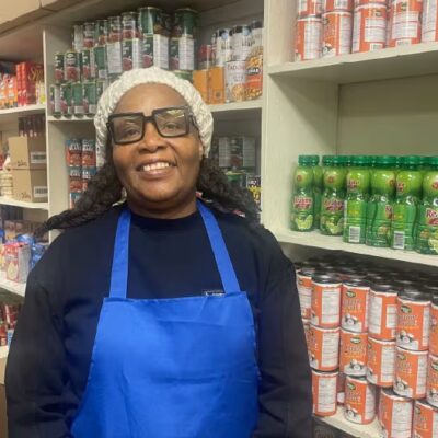 A person standing in front of culturally relevant foods purchased with a Feed Ontario grant.