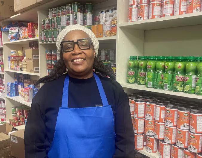 A person standing in front of culturally relevant foods purchased with a Feed Ontario grant.