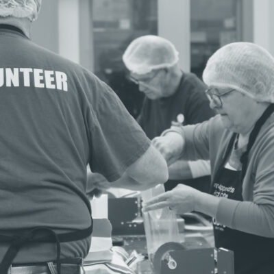 Volunteers process vegetables at a food bank in their community.