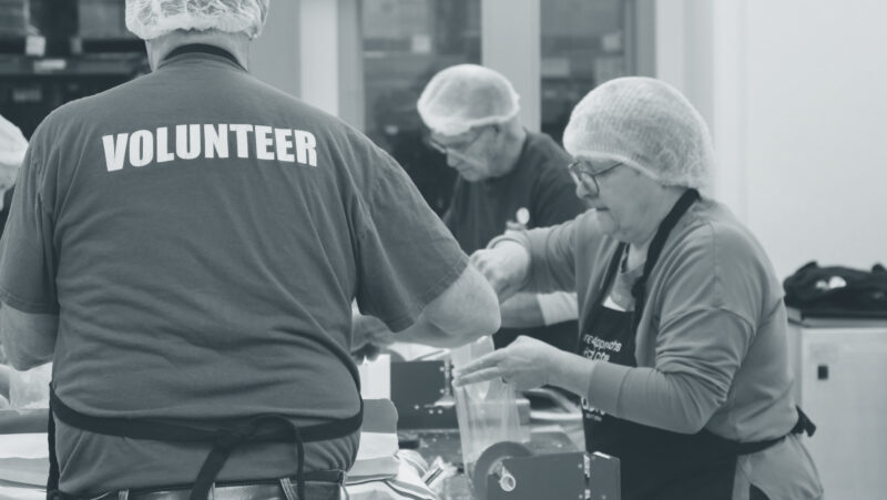 Volunteers process vegetables at a food bank in their community.