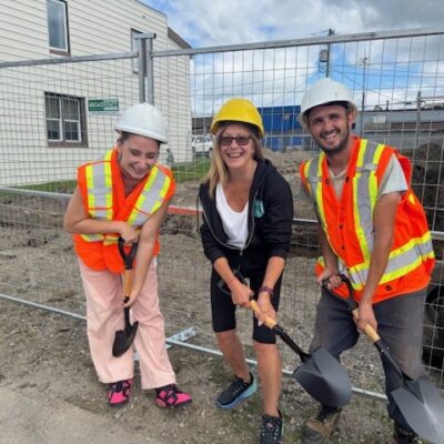 Three people hold shovels at a construction site for the expansion of Cochrane Food Bank - a project intended to make food more accessible to people across Northern Ontario.