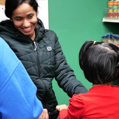 A food bank visitor smiles.