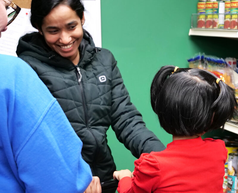 A food bank visitor smiles.