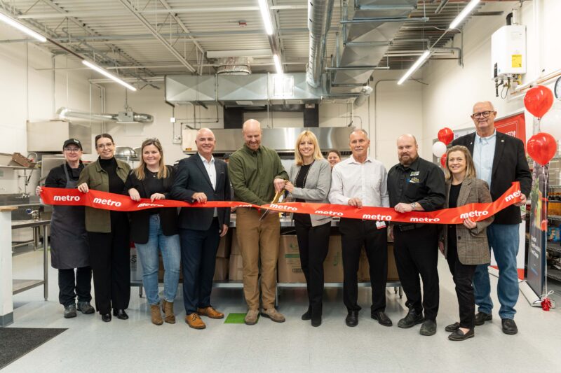 A group of people at a ribbon cutting for the new Metro's Shared Kitchen in Orillia