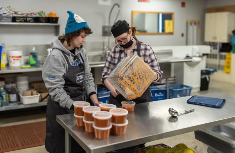 Two volunteers package soup at Renfrew District Food Bank's new kitchen facility.