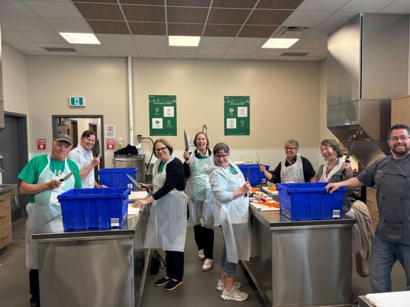 A group of people preparing food in the Metro's Shared Kitchen in Thunder Bay.