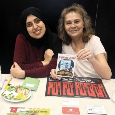 Two women sit at a table together