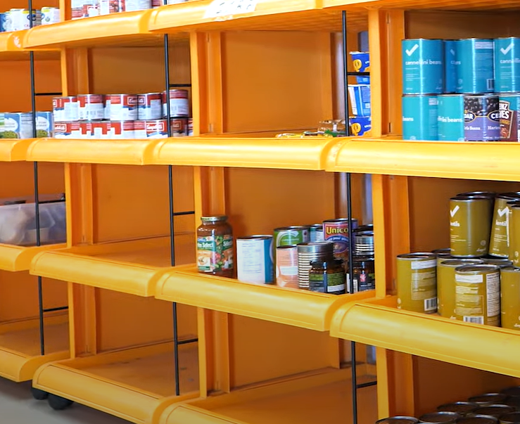 Partially empty food bank shelves.